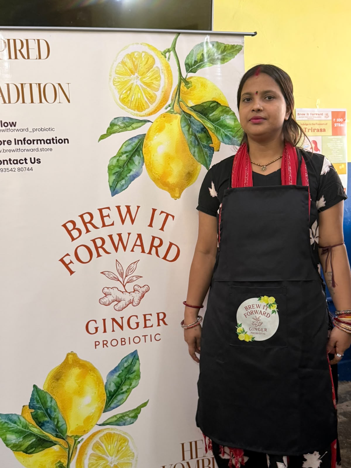 A session participant standing beside the Brew It Forward banner